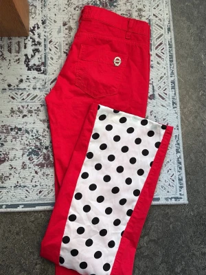 Lågmidjade röda jeans med prickar - sytt bootcut. Storlek 26, tror de kan va xs/s. Märke killah