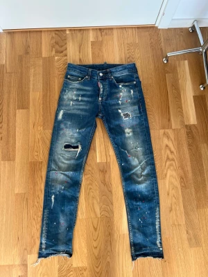 Dsquared2 jeans med slitningar - Säljer ett par riktigt feta Dsquared2 jeans med slitningar i storlek 42. Hör av er vid intresse eller om ni har några frågor!