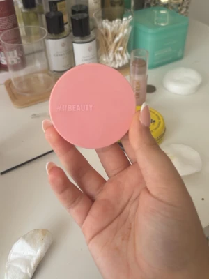 Rosa puderrouge från HAI BEAUTY - Snyggt puderrouge i en mjuk rosa nyans från HAI BEAUTY. Kommer i en rund, kompakt dosa med spegel i locket, perfekt att ha med i väskan. Ger kinderna en fräsch och naturlig look.