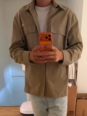 J.Lindeberg  - Helt ny J.Lindeberg overshirt, den har endast används när dessa bilder tagits så den är helt sprillans. Köptes förra året runt jul men aldrig kommit till användning så behöver en ny ägare helt enkelt. Sizen är Large men skulle säga att den funkar för XL lika bra beroende hur man vill att den sitter. Nypris va cirkus 3k+ så det är 50% av nypriset vilket är klippt och skuret.