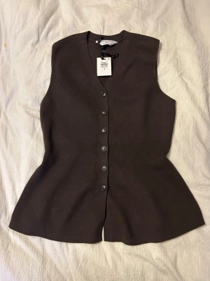Brun ribbad väst med knappar - Snygg brun topp med ribbad struktur och v-ringning.  Toppen har knappar framtill och en lätt utsvängd passform. Från primark helt ny💗