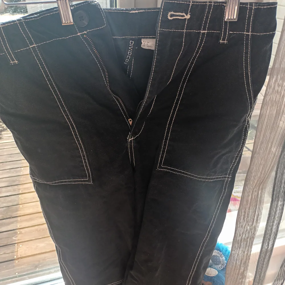svarta cargo byxor med vit sömm. Finns även på HMs webbsida men har sänkt priset :). Jeans & Byxor.