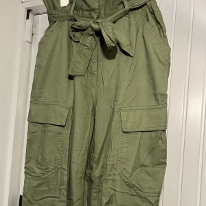 gröna cargo byxor - ett par olivgröna cargo byxor i storlek 36, köpta från h&m divided. de är tänkta att vara highwaisted :) 