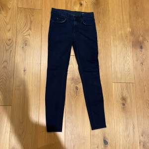Fina mörkblå/svarta jeans från The Local Firm. Storlek 27/34.