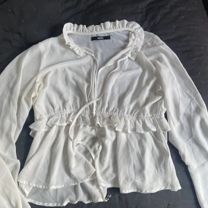 Vit volang topp - En vit volangtopp med lite urringning. Jätte fin och i bra skick köpt secondhand. Är i L men är liten i storleken så passar M/S vid frågor är de bara att skriva💕