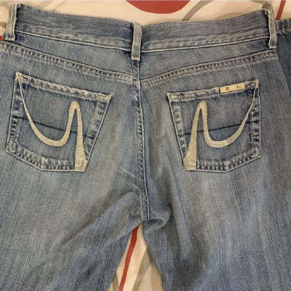 Säljer ett par blåa lågmidjade jeans med hål. Jätte fin ljusblå färg❤️ Det står storlek 38 men skulle säga 34/36, midjemåttet är 38cm rakt över. Jeans & Byxor.