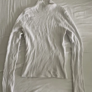 Mockneck stickad topp Bershka - Använd få gånger, gott skick. Storlek M men sitter tight på mig som har S.