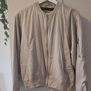 Bomberjacka  - Beige bomberjacka, välanvänd finns några fläckar men går nog att fixa och syns inte vid användning! 