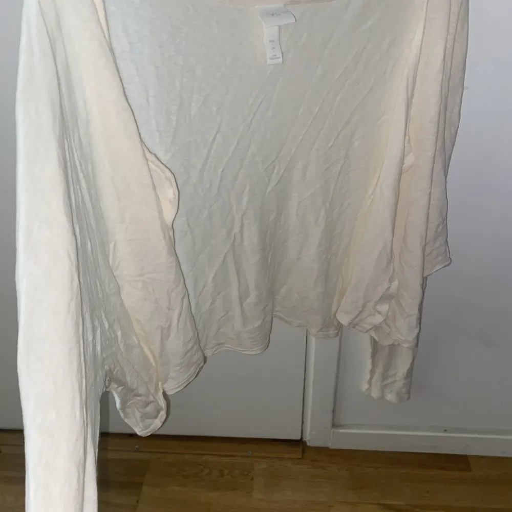 En kräm vit färgad cropped cardigan i ett tunnare material med bruna knappar. Storlek L men passar fint på storlek M. . Tröjor & Koftor.