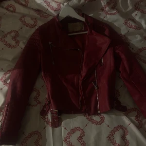 Röd skinnjacka oanvänd - Röd skinnjacka i bra material och helt oanvänd i storlek 36 men Passar även 34