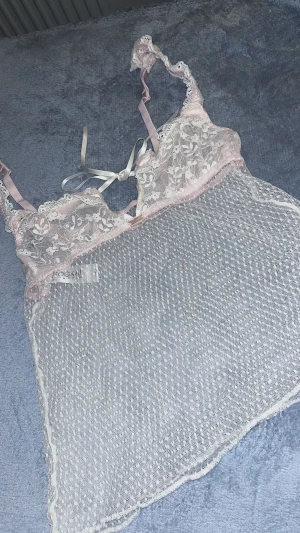  Lingerie YK2 - Detta är en ljus rosa Lingerie. Den är otroligt fin med en Liten rosett. Nederdelen är lite utsvängd så den formar sig lite runt kroppen. Står tyvärr ingen storleksbeskrivning men hade gissat på S. Kan användas som underkläder men även stylas. YK2