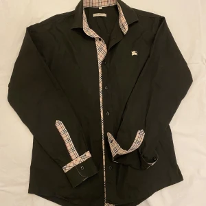 Burberry skjorta - Säljs billigt! Perfekt skick. Storlek M. Passar mig som är 182 och 77kg. Diskuterbart pris. För fler frågor, skriv! 