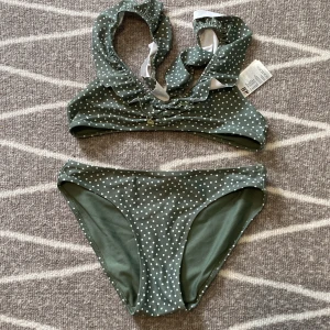 Prickig bikini - Jättefin grön bikini från H&M. Är i bra skick och ser så gott som ny ut!