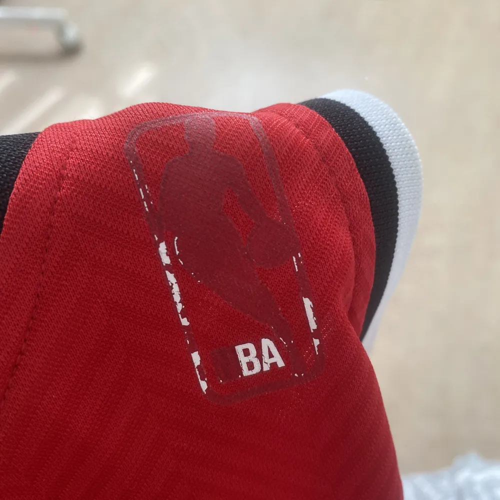 röd baskettröja från adidas! har en rätt så stor defekt på sista bilden + lite på adidasloggan ❤️. T-shirts.