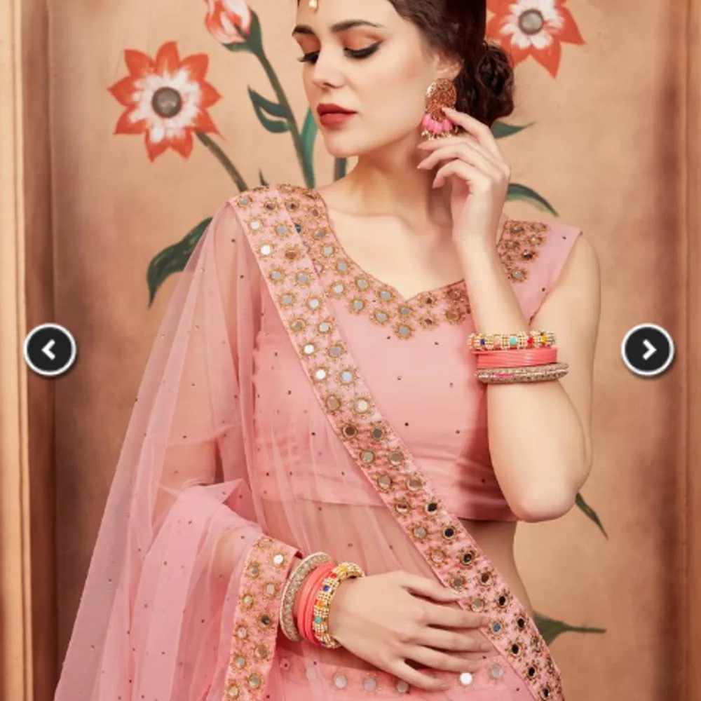 Peach lehenga with net work underneath with blouse and dupatta (scarf). Klänningar.