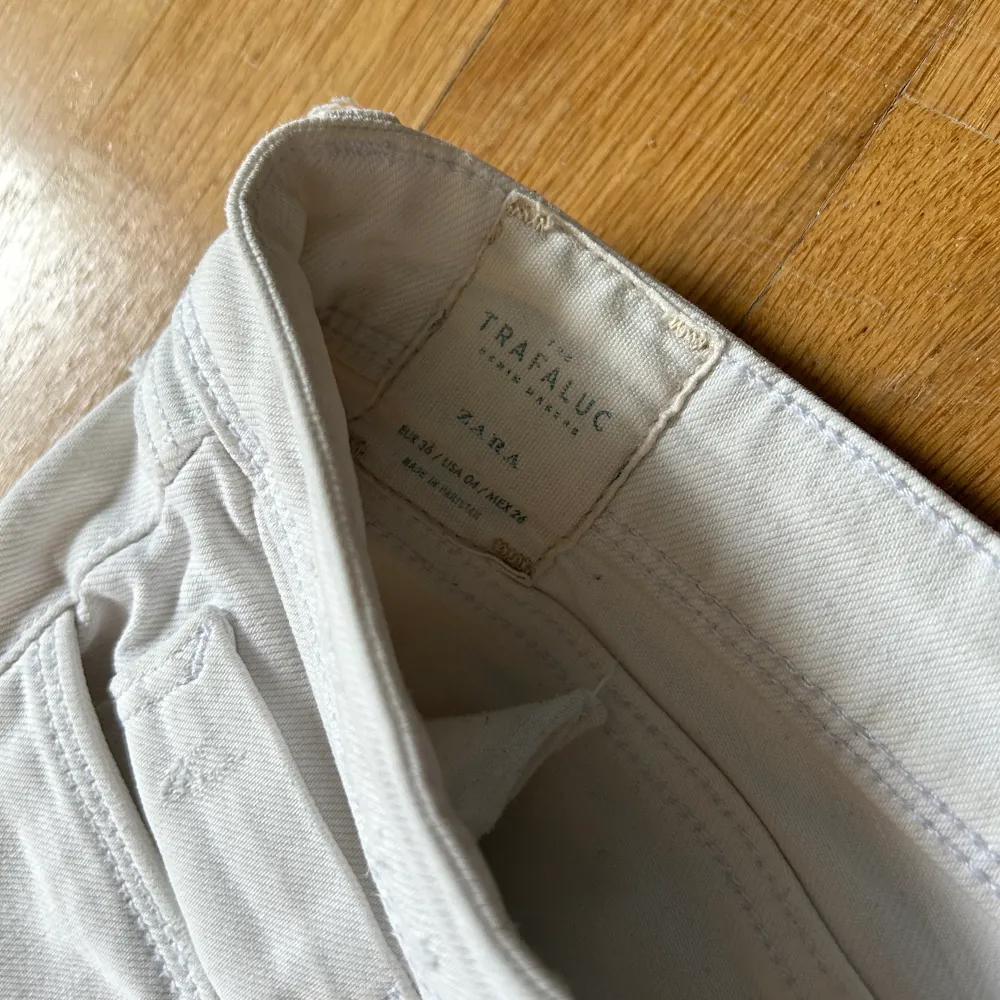 Vita lågmidjade jeans med lite slitningar från Zara Storlek 36. Jeans & Byxor.