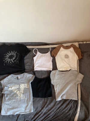 Tröjpack - Säljer ett pack med tröjor. 4 croptops och två korta linnen. Tröjorna är storlek Xs förutom den med solen som är storlek 12-13 år. Linneorna  är storlek XSS. Säljer allt för 50kr, man behöver inte köpa hela packet man köpa dem styck också 💗