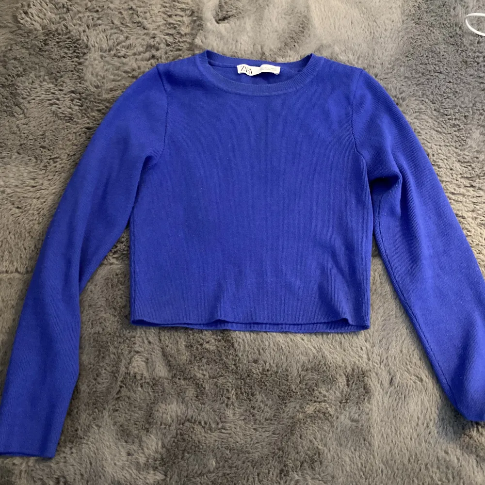 En långärmad tröja, som slutar ungefär vid magen, beroende på längd, jätte fin blå färg  Köpt på Zara. Toppar.
