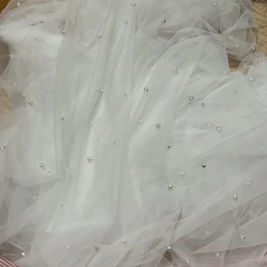 Bröllopsslöja  - Helt oanvänd bröllopsslöja, vit och med pärlor, ett stabilt hårspänne som fäster bra i håret. Ca. 2m lång men går enkelt att skustera. 