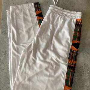 Used one time, like new! Track pants with print details.