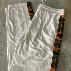 Track pants  - Used one time, like new! Track pants with print details.