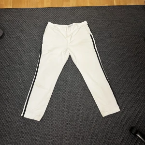 White straight pants - White pants with black stripes on the side. Used a couple of times but nothing is broken of dirty.  They are kind of big ok me and i am S so it Will fit M & L