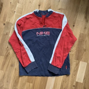 Nike sweater - Vintage Nike Athletic sweater. Inköpt på second hand för några år sedan men har aldrig funnit tillfällen att använda den. Riktig cool och retro i färgerna röd, gråblå och vit. Skick: Tydligt använd (men det är från innan jag köpte den på second hand) 