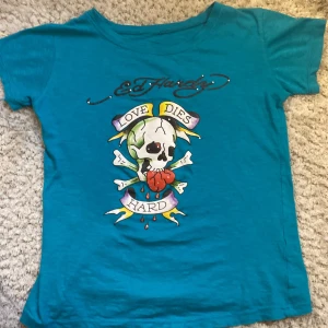 Ed Hardy  - Säljer min Ed Hardy t-shirt då den inte kommer till andvändning längre! Köpt secondhand, använts 2-3 gånger! Bra skick förutom att den tappat några diamanter som man kan se på sida 2😊 kontakta för fler bilder💕😁✨tröjan är turkos💙💚frakt kostar 80kr😁