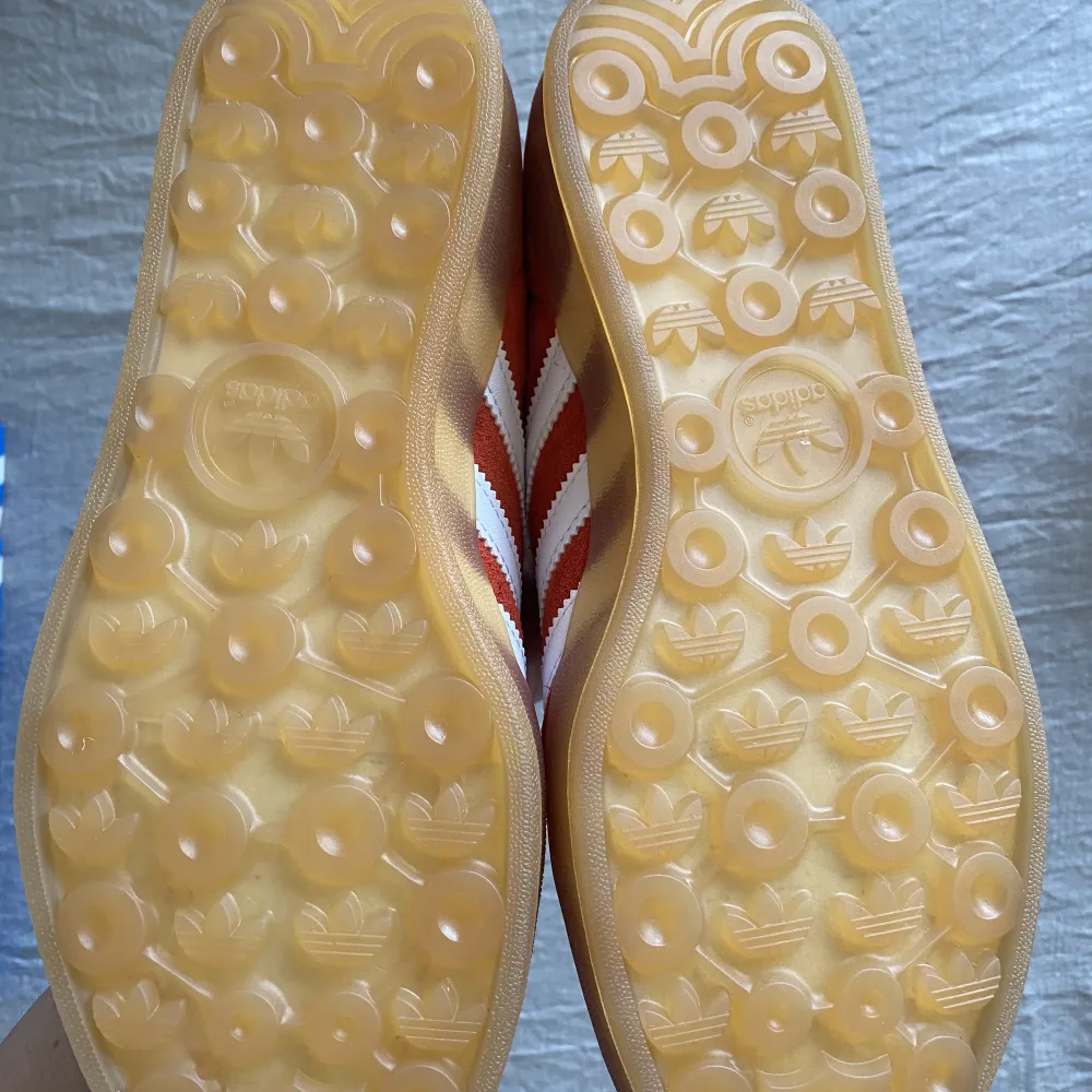 Röda Adidas sneakers i mocka med gummisula. Helt nya och oanvända i originalförpackning med prislapp och alla tillbehör till. ❤️‍🔥Storlek 38 2/3, UK 5.5. Extra vita snören tillkommer.❤️‍🔥. Skor.