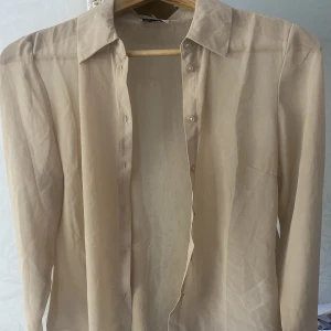 Beige blus  - Blus från Emma Ellingsen x NA-KD Knappt använd Saknar storleksangivelse men den sitter som en XS-S