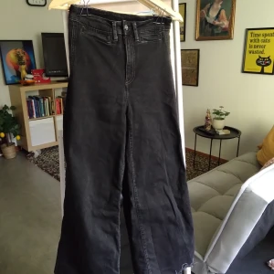 High waist, wide leg denim with distressed hem. - Svarta denimbyxor med sliten fåll. Högmidjad med baggy-byxben. Använda byxor i gott skick.