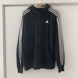 Svart adidas hoodie - Svart adidas hoodie. Har haft den länge och den är lite sliten på sina ställen så sätter lågt pris 