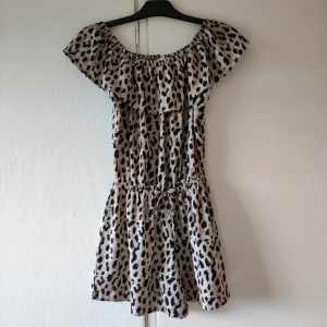 Loepardpintad byxdress - Leopardprintad byxdress, kortärmad och med shorts. Volangarmar i storlek 158