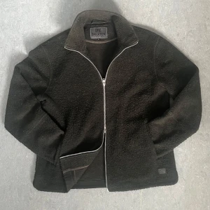 Mörkgrön fleecejacka från Brixtol - Säljer en och skön mörkgrön fleecejacka från Brixtol textiles. Den har en dragkedja framtill och är perfekt för kyliga höst- och vårdagar. Den är långärmad och har en normal passform och är i ett bra skick.