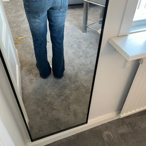 Blå bootcut jeans - Säljer ett par klassiska blå bootcut jeans med snygg tvätt. De har en bekväm passform och är perfekta för en avslappnad stil. 