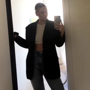 Svart kavaj i twill - Elegant svart kavaj med tre knappar framtill och klassiska fickor. Perfekt för formella tillfällen eller som en stilren vardagskavaj. Passar bra till både byxor och jeans.