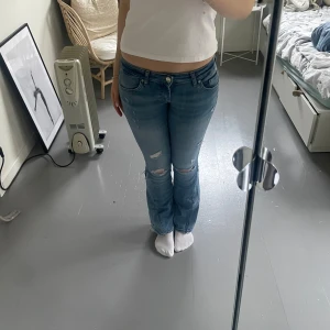 Blå jeans från ONLY - Säljer ett par lågmidjade blåa jeans från ONLY. Jag har gjort om de till bootcut, se bild 3, med hjälp av lim som håller i tvätt🤗Storlek 27/32. Säljer eftersom de inte kommer till användning!