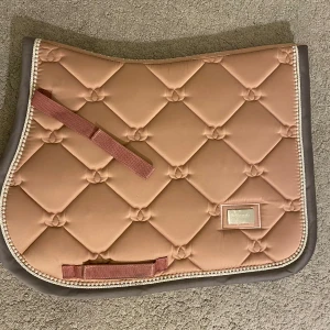 Rosa pink pearl equestrian schabrak  - Säljer detta super fina rosa equestrian Stockholm schabraket i strl ponny. Jättefint skick och används endast en gång. Färgen är jätte fin och den har små pärlor på kanterna. 