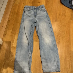 Ljusblå jeansbyxor - Säljer ett par ljusblå jeansbyxor med en klassisk femficksdesign. Byxorna har en rak passform och är tillverkade i denim. Perfekta för en avslappnad stil.