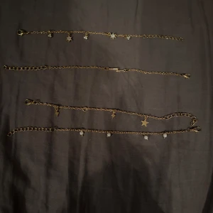 Guldarmband med stjärnor och blixtar - Fyra eleganta guldarmband med olika hängen. Vissa armband har små stjärnor och gnistrande stenar, andra har blixtformade hängen. Perfekta för att mixa och matcha för en unik stil. Köpta på shein. Kan köpas separat om så önskas. Aldrig använda.