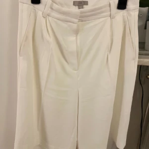 Vita kostymbyxor från H&M - Eleganta vita kostymbyxor från H&M med hög midja och stilren design. Perfekta för en chic och sofistikerad look.