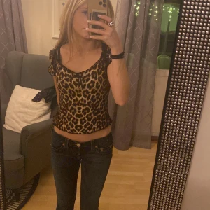 Leopardmönstrad topp - Säljer en leopardmönstrad topp i storlek XS. Toppen har en tight passform och korta ärmar med en snygg offshoulder-design. Perfekt för en trendig look!