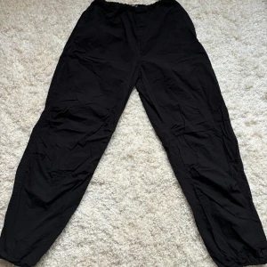 Parachute pants från Stradivarius  - Svarta parachute/ballong byxor från Stradivarius i bra skick. Storlek M men har krympt i tvätten så passar nog mer en s beroende på hur tjata man vill ha de. Justerbara i midja och ankeln. För referens så är jag 158 cm. 