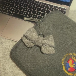 Bagcharm med grå rosett - Snygg grå dekorativ rosett som passar perfekt på din väska eller nyckelring. (Vi erbjuder även att mötas upp i söder, huddinge, tyresö, lidingö.)