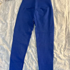 Blå leggings från Relode - Snygga blå leggings från Relode med hög midja. Perfekta för träning med en tight passform som ger bra stöd. Materialet är stretchigt och bekvämt, vilket gör dem idealiska för intensiva träningspass.