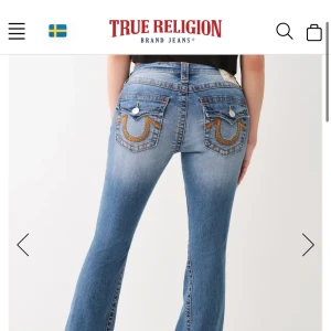 Blå jeans från True Religion - Snygga blå jeans från True Religion med låg midja och flare-stil. De har dekorativa sömmar på bakfickorna och en klassisk femficksdesign. Endast andvänd 2 gånger, helt nya 