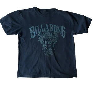 Billabong tee - t-shirt från Billabong med ett stort tryck på framsidan. lite hål finns, se bilder. Den är lite ljusare i verkligheten.