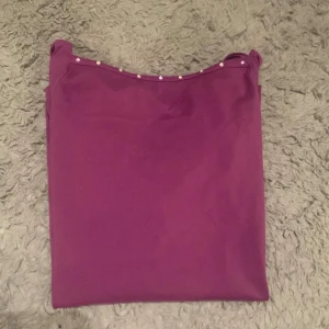 Lila långärmad topp från Karisma - Säljer en snygg lila långärmad träningströja titta-topp från Karisma Scandinavia! Tråd har farit upp på armen men det är inget som märks av 