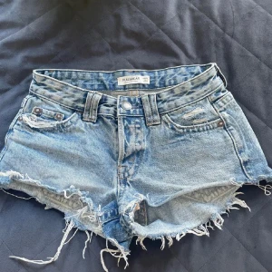 Blå jeansshorts  - blå jeansshorts från Pull&Bear med fransiga kanter, fickor med knapp baktill💕