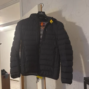 Svart pufferjacka från Parajumpers - Säljer en svart pufferjacka från Parajumpers med dragkedja och huva. Köpte den för 1 månad sen för cirka 4 tusen kronor , har använt den 1 gång. Den passade inte på mig som jag ville. (Kvitto finns, PRIS KAN DISKUTERAS!) 